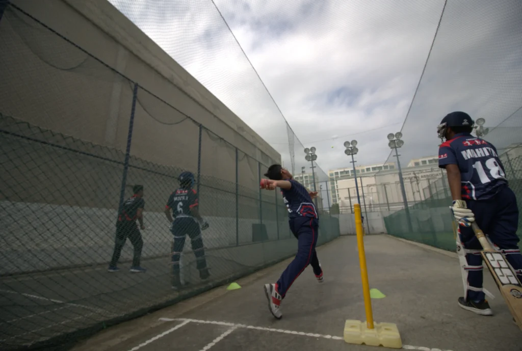 Natural turf cricket nets under floodlights at Oud Metha