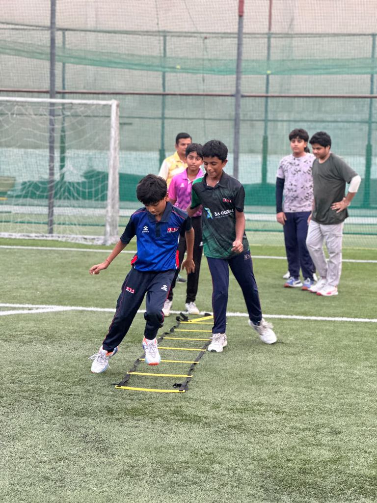Young cricketer doing an agility ladder footwork drill at SPSA Oud Metha